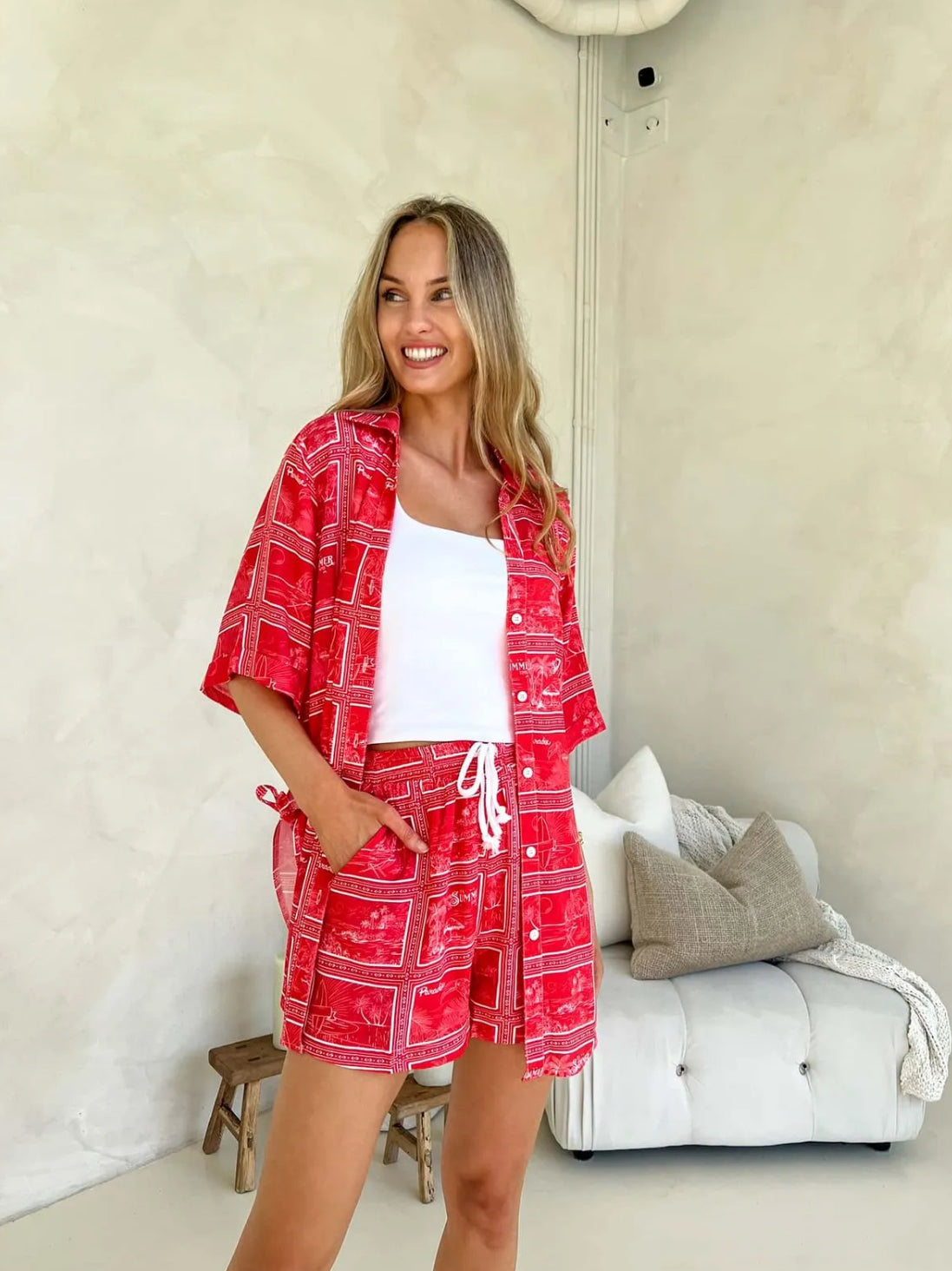 Full view Model wearing Summer Set – matching red printed shirt and shorts with white drawstring waist and bold tropical holiday print