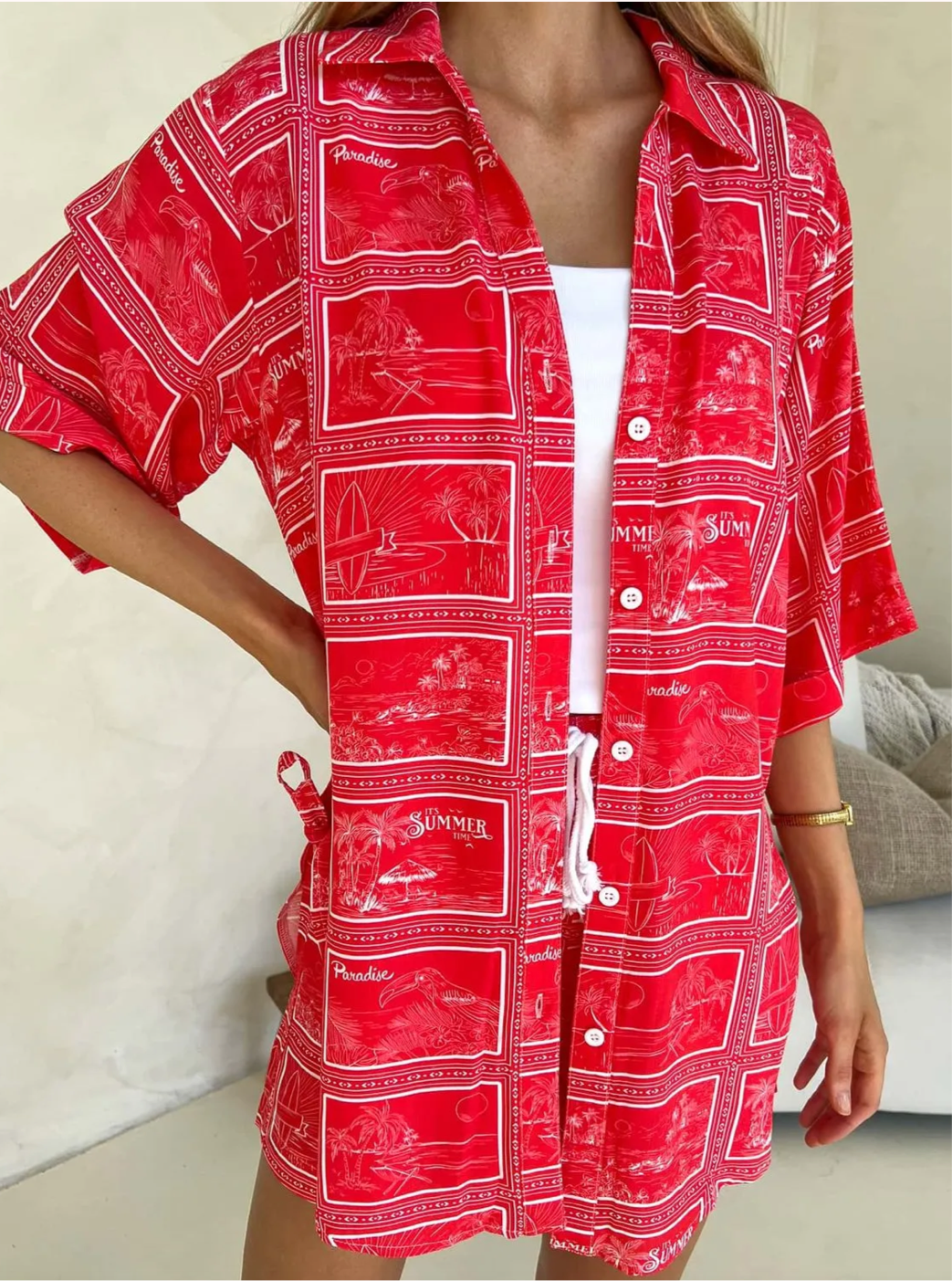 Close up Model wearing Monroe Avenue Summer Set – matching red printed shirt and shorts with white drawstring waist and bold tropical holiday print