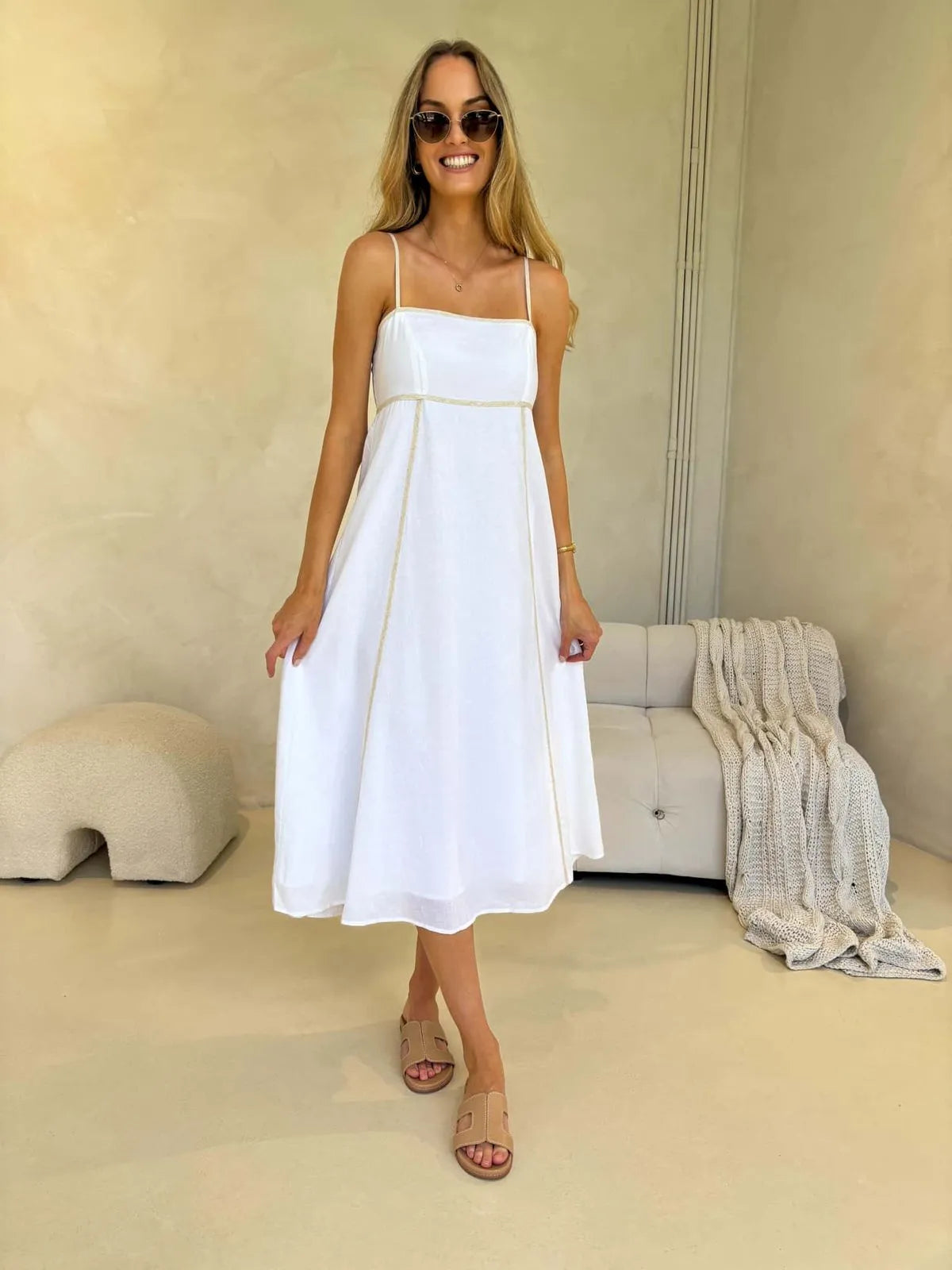 Model wearing white midi sundress with thin straps and contrast stitching, styled with sunglasses and sandals – Juniper Dress | Monroe Avenue
