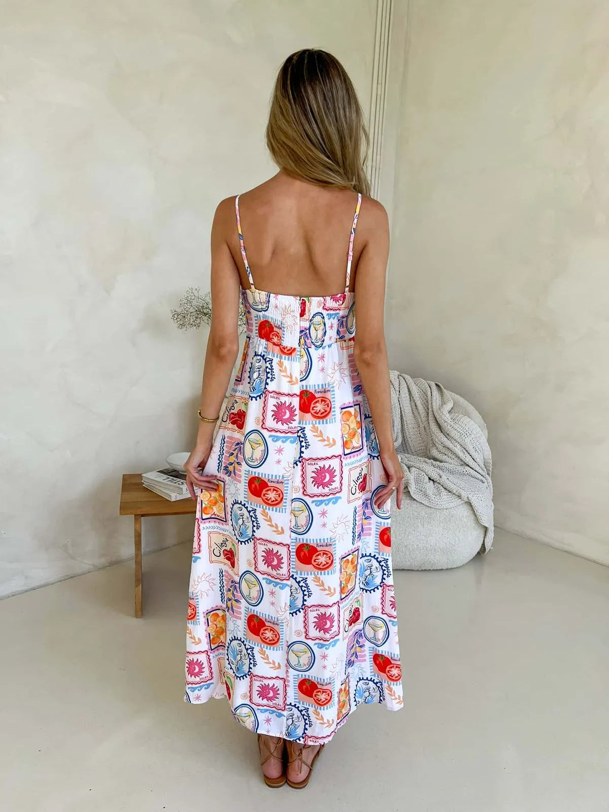 Back view of Cameo midi dress for women with adjustable straps, shirred back, and bold boho summer print.