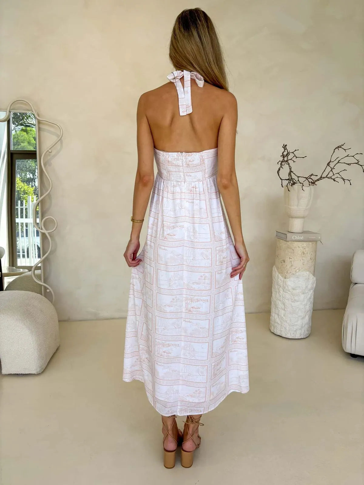 Back view of women's halter neck midi dress in soft ink print, flowy summer style, perfect for beach sundress Australia